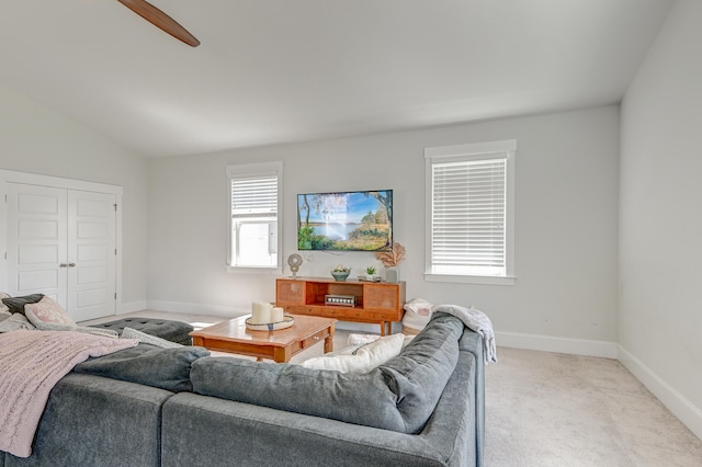 carpeted living room featuring vaulted ceiling and ceiling fan