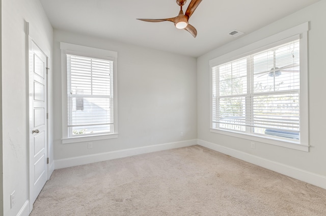 carpeted empty room featuring ceiling fan