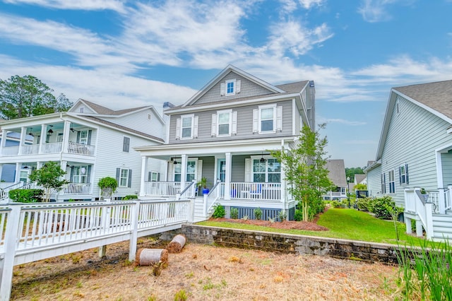 view of front of property with covered porch, a balcony, and a front lawn