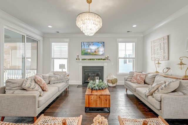 living room with dark hardwood / wood-style floors, crown molding, and plenty of natural light