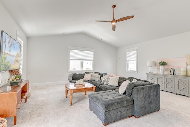 living room with ceiling fan, vaulted ceiling, and light carpet