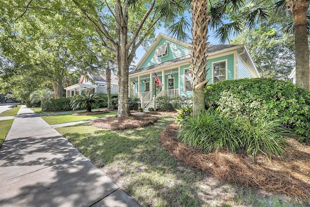 view of front facade with a front yard and a porch