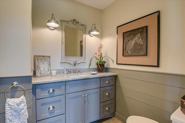 bathroom featuring toilet and vanity