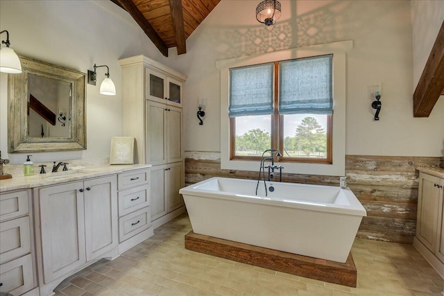 bathroom with vanity, a bathing tub, tile floors, lofted ceiling with beams, and wood ceiling