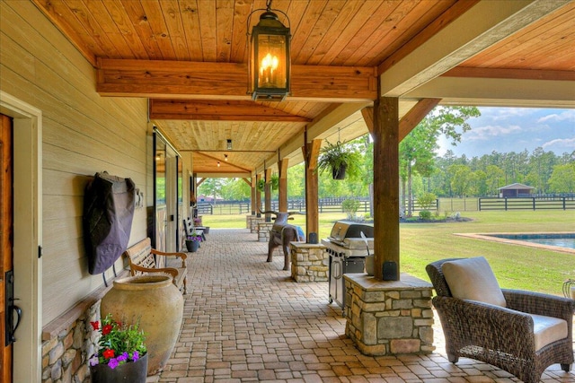 view of patio featuring area for grilling and a grill