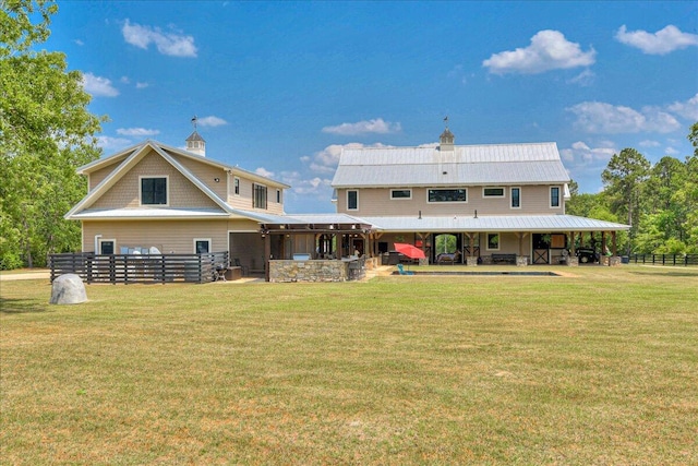 back of house featuring a lawn and a patio