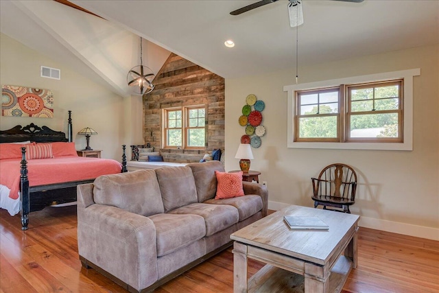 living room with a healthy amount of sunlight, ceiling fan, and light hardwood / wood-style flooring