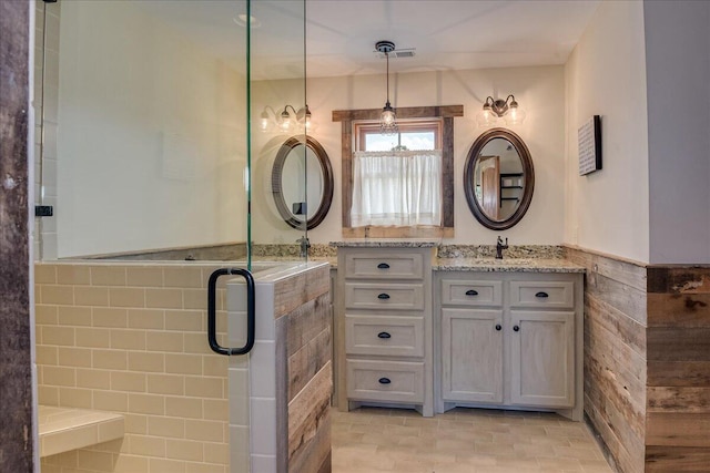 bathroom with a shower with door, large vanity, and tile flooring