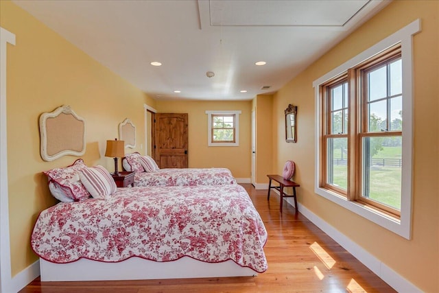 bedroom featuring multiple windows and light wood-type flooring