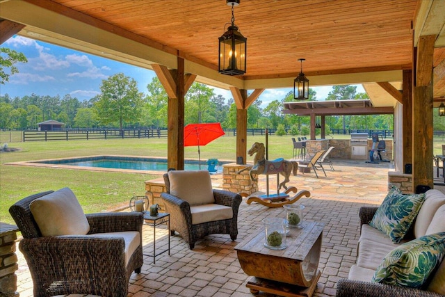 view of patio / terrace with outdoor lounge area, an outdoor kitchen, and a fenced in pool