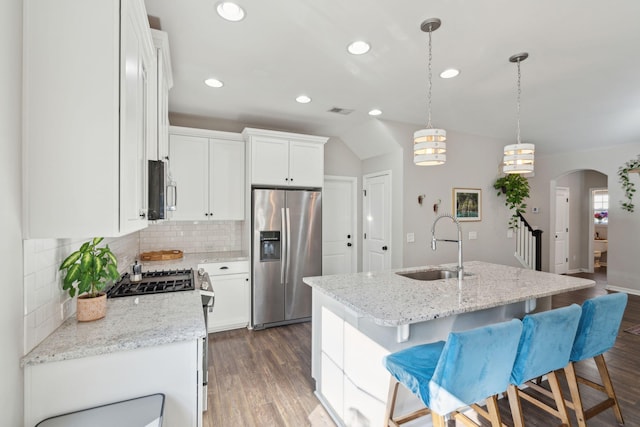 1606 Stovall Ct, Johns Island, SC 29455 - kitchen featuring stainless steel appliances, a sink, arched walkways, recessed lighting, and decorative backsplash