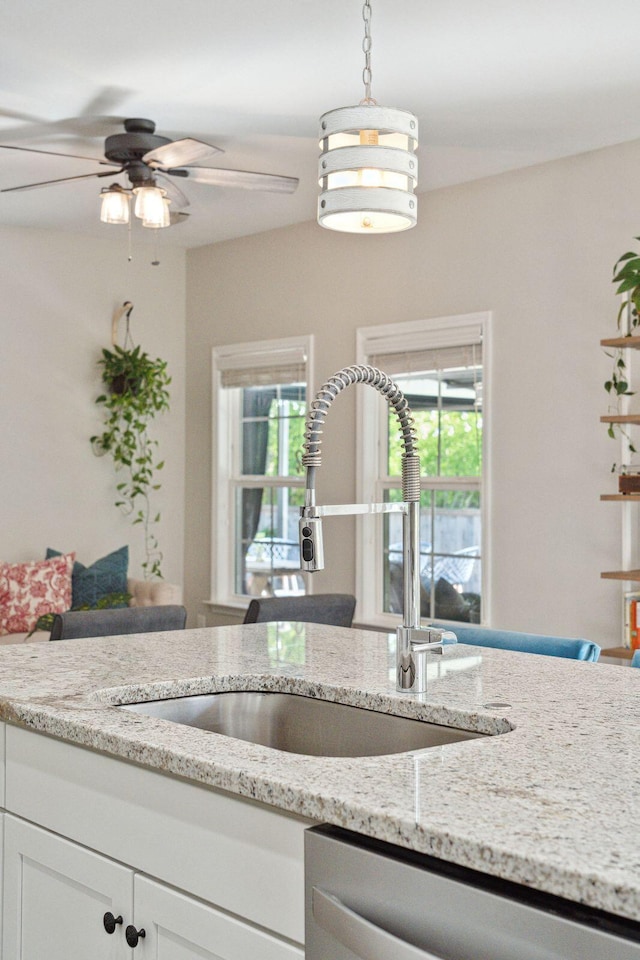 1606 Stovall Ct, Johns Island, SC 29455 - kitchen with white cabinets, a sink, a ceiling fan, light stone countertops, and dishwasher