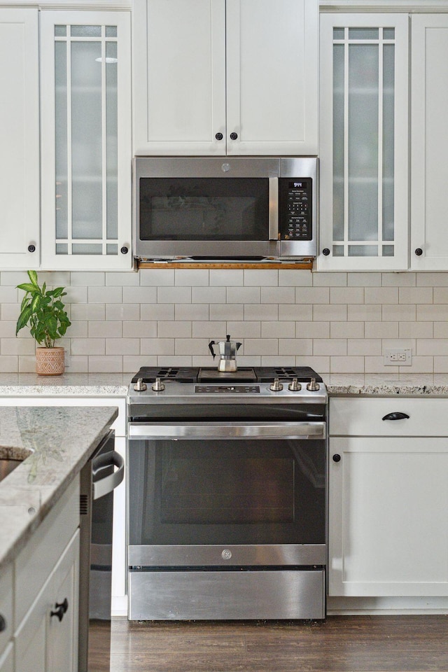 1606 Stovall Ct, Johns Island, SC 29455 - kitchen featuring dark wood-style flooring, white cabinetry, stainless steel appliances, and glass insert cabinets