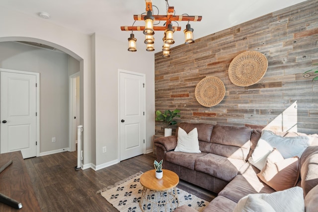 1606 Stovall Ct, Johns Island, SC 29455 - living room featuring an accent wall, wood finished floors, arched walkways, baseboards, and wood walls