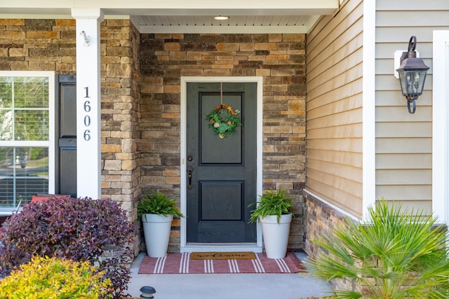 1606 Stovall Ct, Johns Island, SC 29455 - property entrance featuring brick siding, a porch, and stone siding