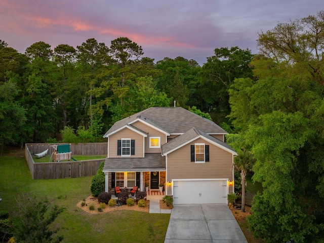 1606 Stovall Ct, Johns Island, SC 29455 - traditional home with a porch, fence, concrete driveway, an attached garage, and a lawn