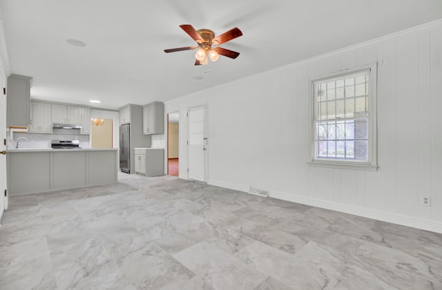 unfurnished living room with crown molding and ceiling fan