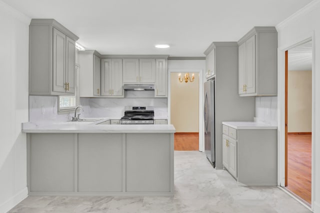 kitchen featuring gray cabinets, kitchen peninsula, light wood-type flooring, and stainless steel appliances