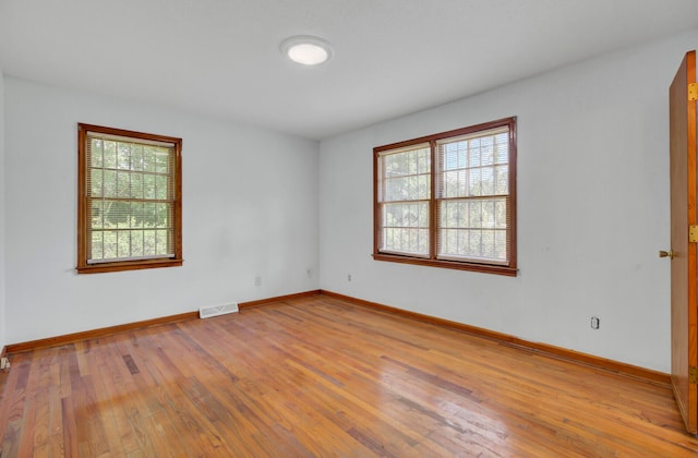 spare room featuring light wood-type flooring