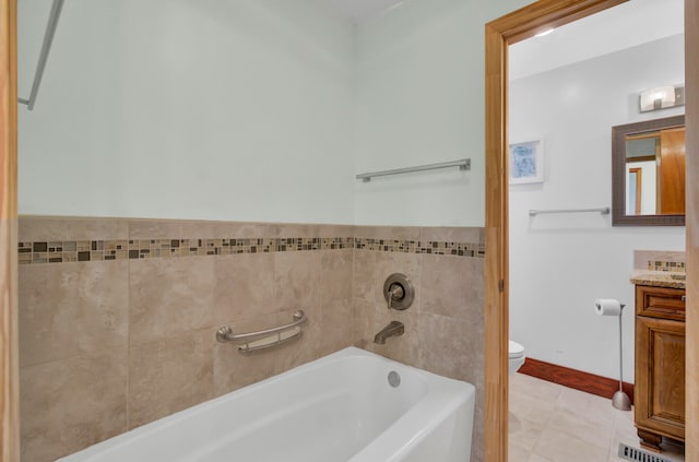 bathroom with vanity, a bathtub, tile patterned flooring, and toilet