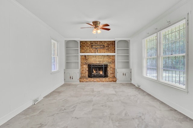 unfurnished living room with ceiling fan, a fireplace, ornamental molding, and built in shelves