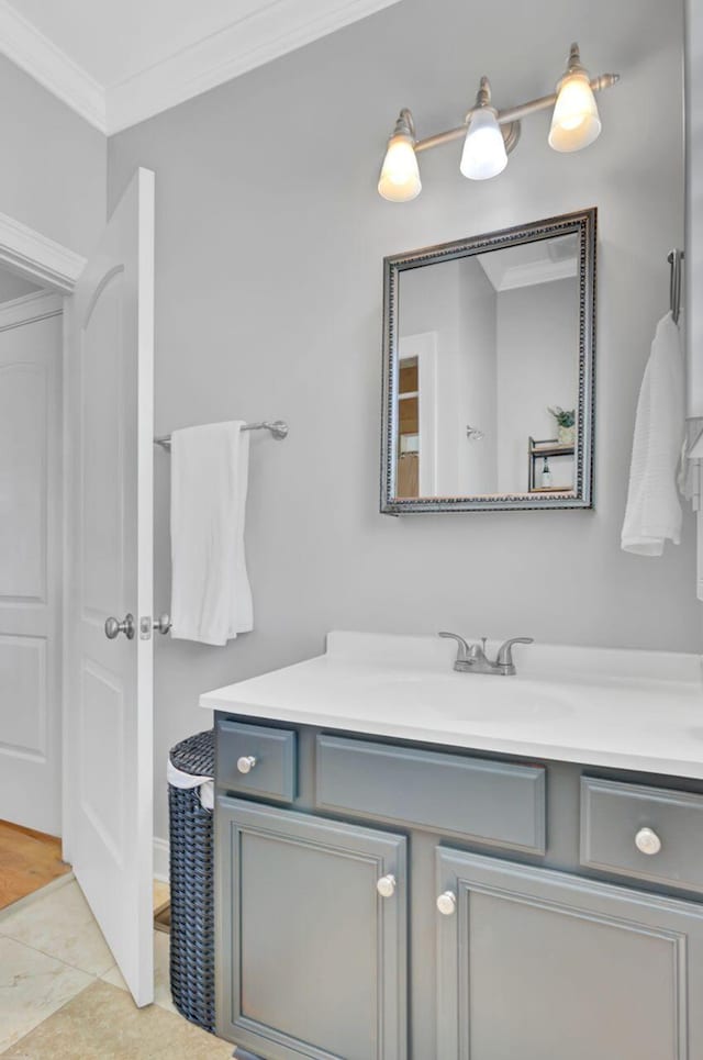 bathroom featuring tile patterned flooring, vanity, and ornamental molding