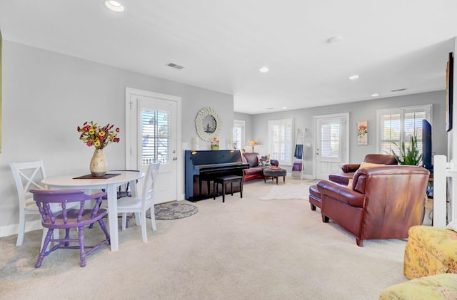 living room featuring baseboards, carpet floors, visible vents, and recessed lighting
