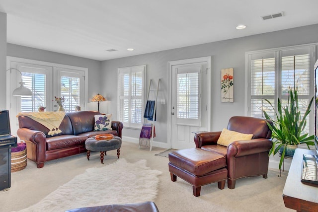 carpeted living room featuring baseboards, visible vents, french doors, and recessed lighting