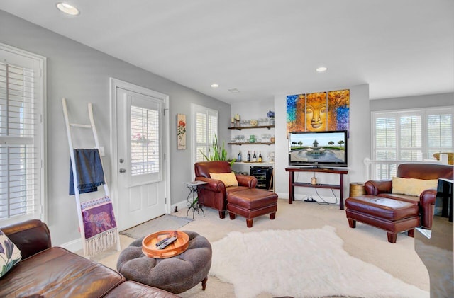 living room featuring plenty of natural light, carpet, baseboards, and recessed lighting