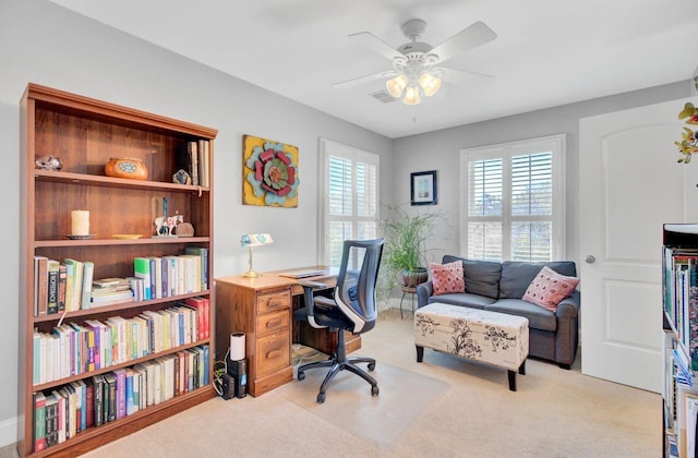 home office with ceiling fan and carpet