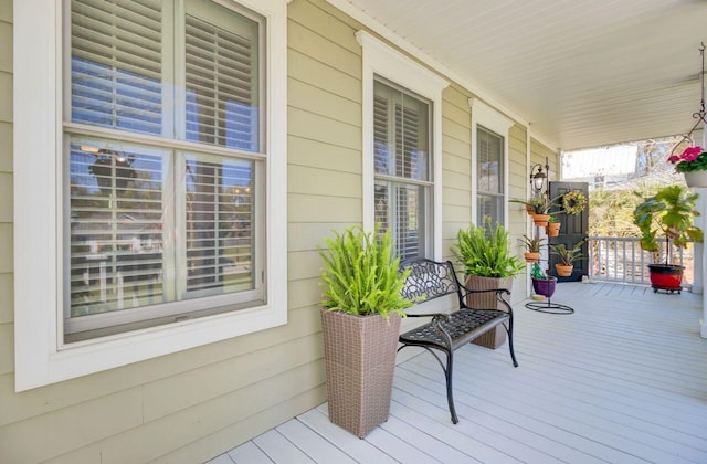 wooden terrace featuring covered porch