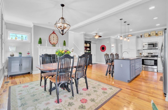 dining area with baseboards, ornamental molding, recessed lighting, and light wood-type flooring