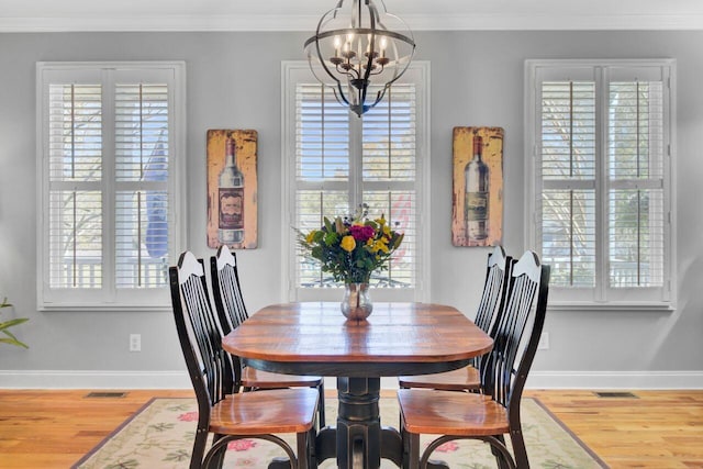 dining space featuring ornamental molding, a notable chandelier, and plenty of natural light