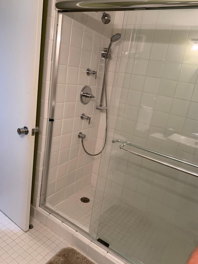 bathroom with tile patterned flooring and an enclosed shower