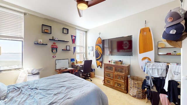 carpeted bedroom with ceiling fan