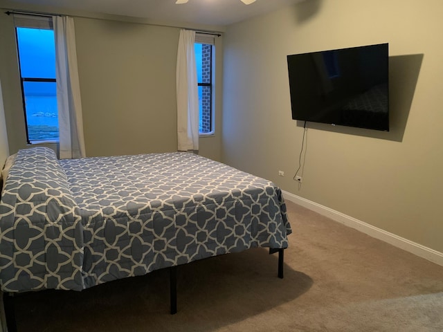 carpeted bedroom with ceiling fan