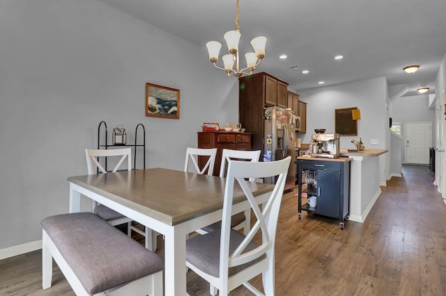 dining room with a chandelier and dark hardwood / wood-style floors