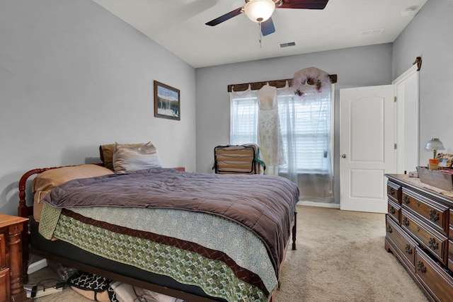 bedroom with light carpet and ceiling fan