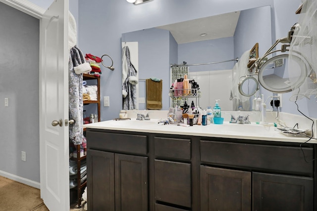 bathroom featuring tile patterned flooring, vanity, and curtained shower