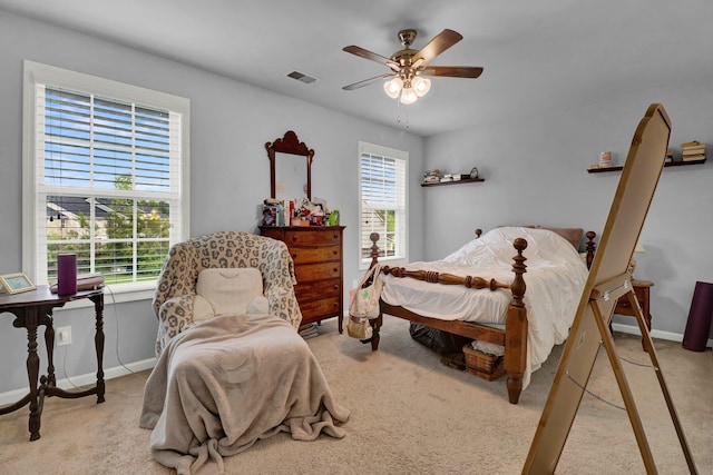 bedroom featuring multiple windows, light carpet, and ceiling fan