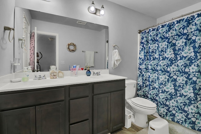 bathroom featuring vanity, curtained shower, and toilet