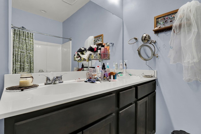 bathroom featuring vanity and a shower with shower curtain