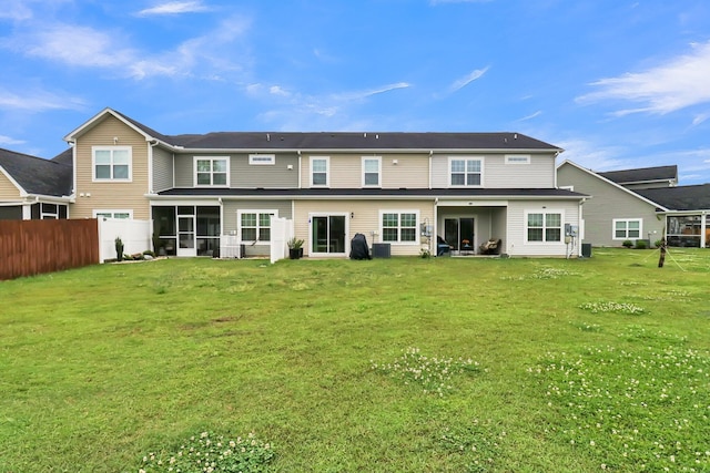 rear view of property featuring a yard