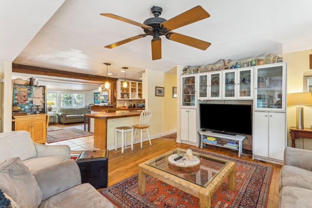 living room with ceiling fan, sink, and light hardwood / wood-style floors