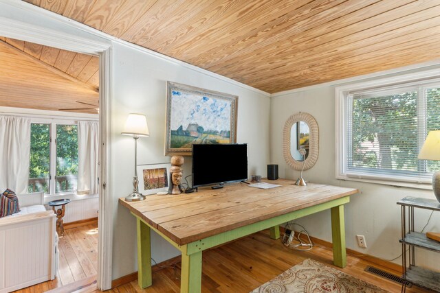 home office featuring crown molding, vaulted ceiling, light wood-type flooring, and wooden ceiling