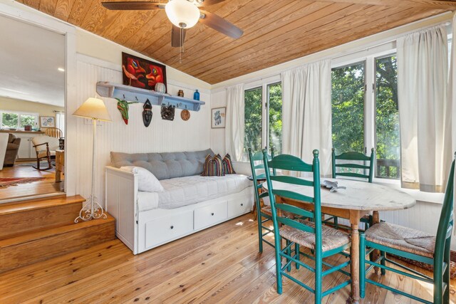 living room featuring a wealth of natural light, vaulted ceiling, ceiling fan, and light hardwood / wood-style floors