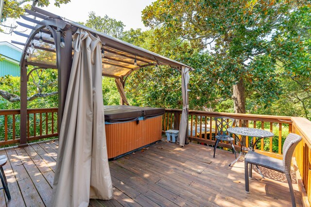 wooden deck with a hot tub