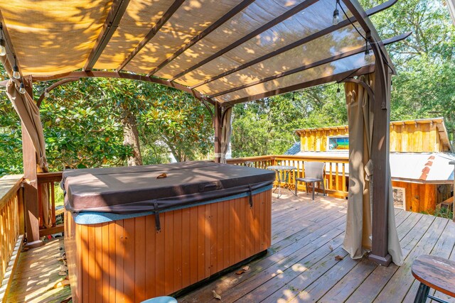 wooden deck featuring a hot tub