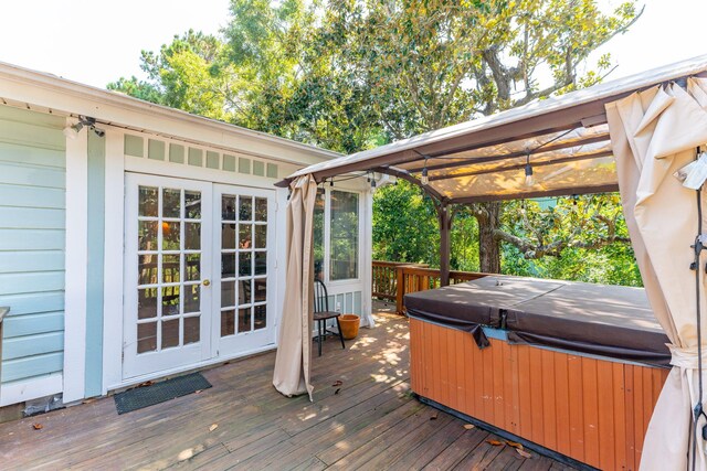 wooden terrace featuring a hot tub