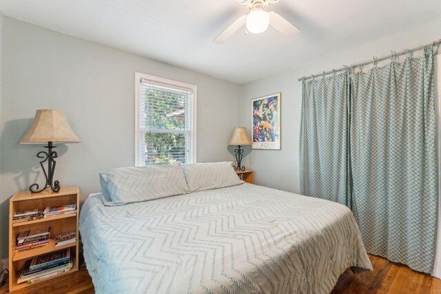 bedroom featuring ceiling fan and dark hardwood / wood-style floors